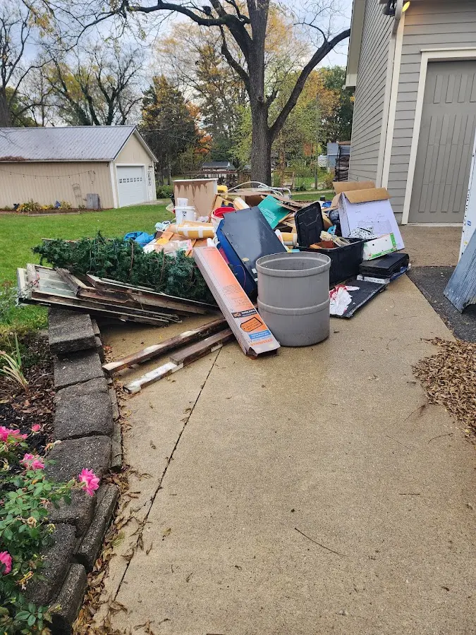 Dumpster being loaded with debris for Commercial Dumpster Rental in Van Alstyne
